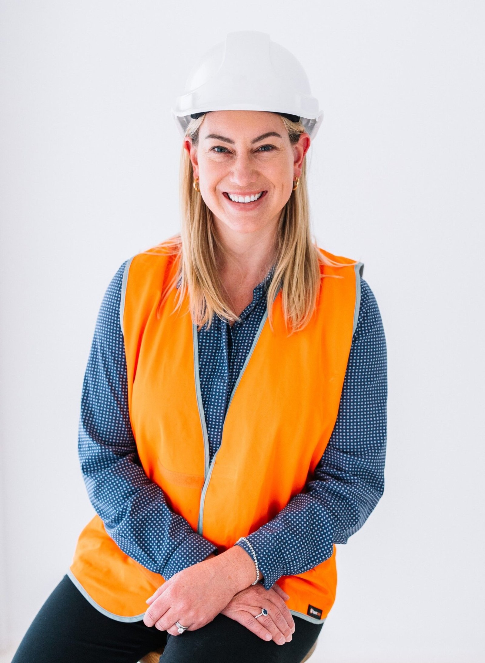 Smiling woman in an orange high-visibility vest