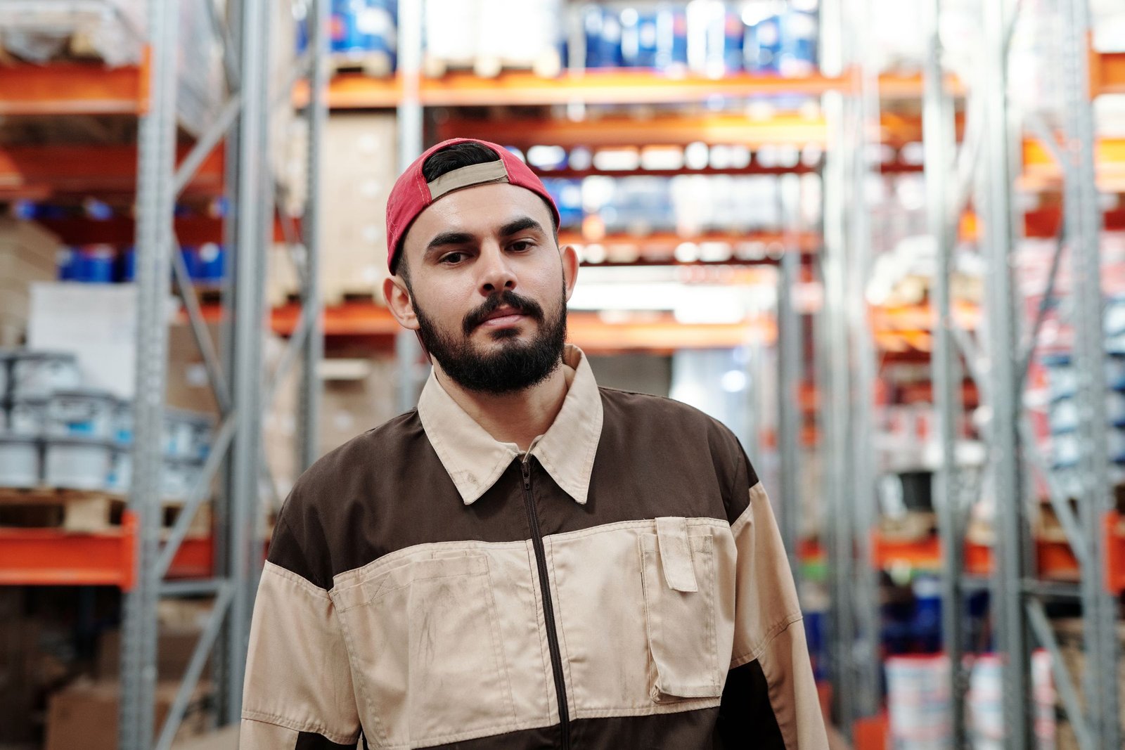Worker in a work jacket in a warehouse