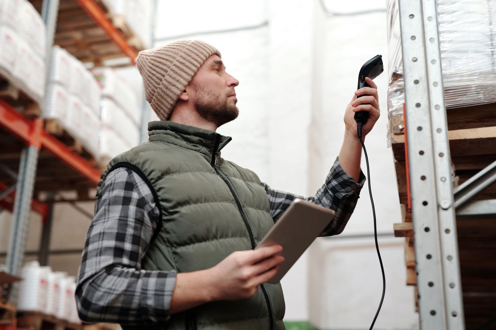 Warehouse worker scanning goods at a rack
