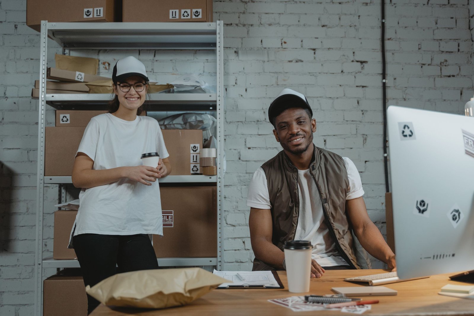 Two smiling colleagues in a shipping room
