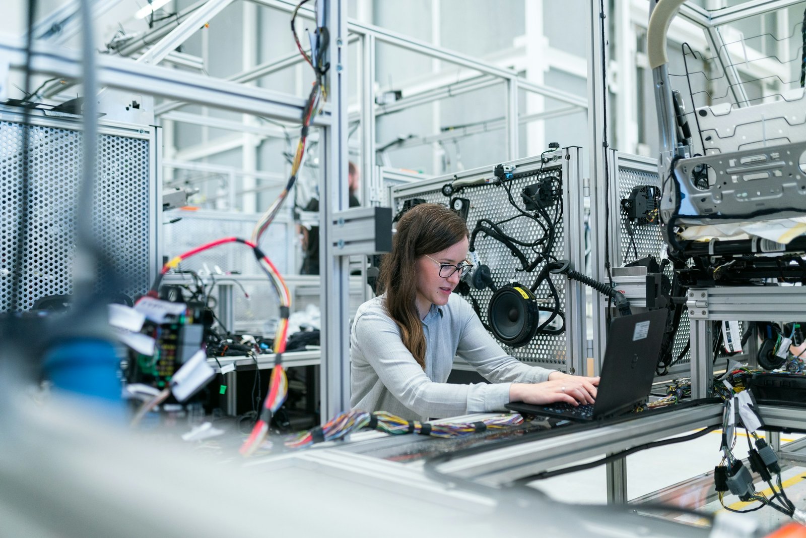 Technician working on a laptop at a test rig on the production floor